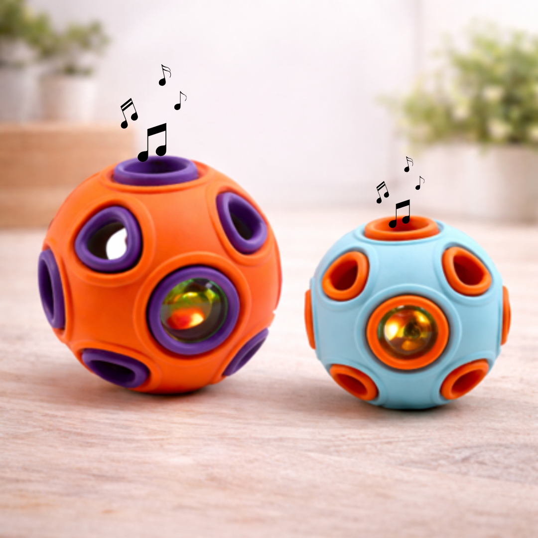 Two colorful puzzle balls with musical notes on a wooden surface